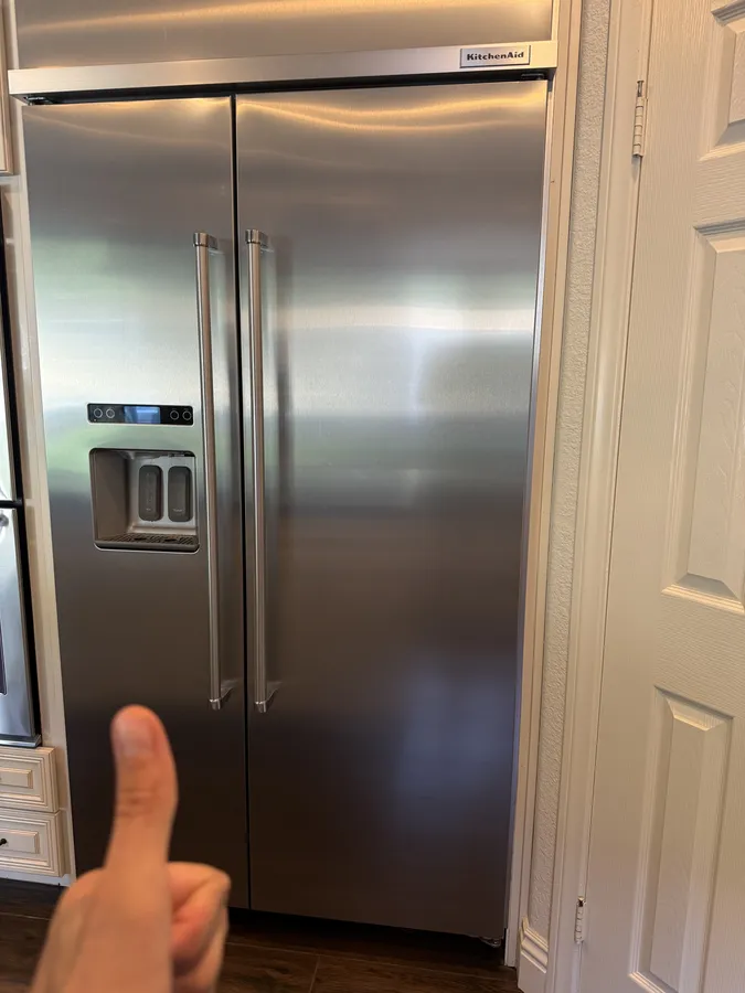 Technician confirming a refrigerator fix in La Jolla
